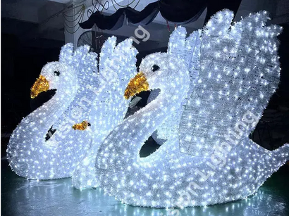 Cygne illuminé dans le parc d'attractions et le jardin